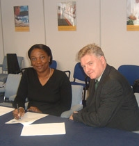 Feyi Raimi-Abraham and Michael Whiteley sign the agreement