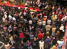 Members crowd round union speakers at a Television Centre meeting